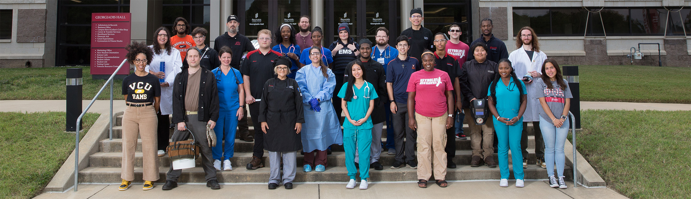 Diverse Reynolds students standing outside a Reynolds campus building
