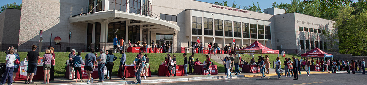 . A crowd of people gathered in front of the Library Technology Center.