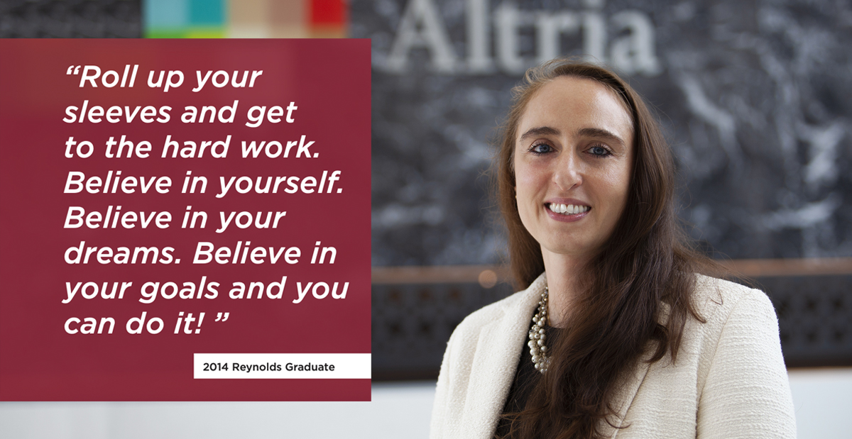 Cristina Childers, woman with long, dark hair, wearing white blazer, smiles at camera in front of Altria sign