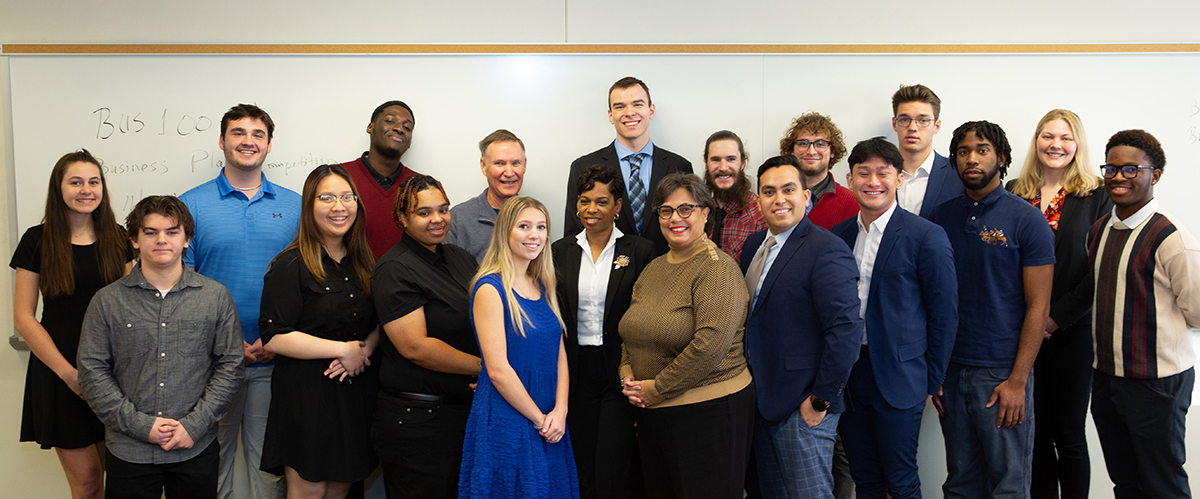 The Reynolds Introduction to Business class poses with their instructor, Dr. Bowers, and two judges.