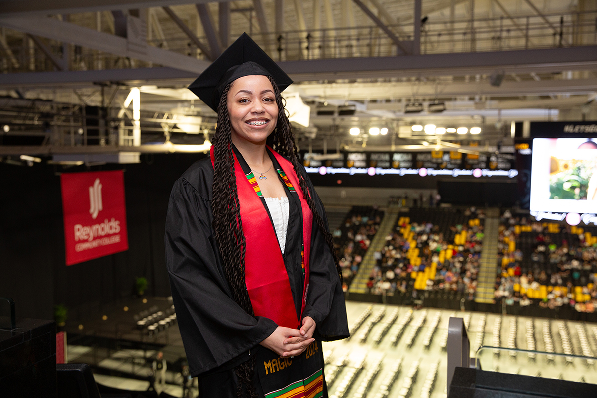 Samantha Carter, Reynolds Spring Graduation speaker, smiles at the camera from high in the Siegel Center.