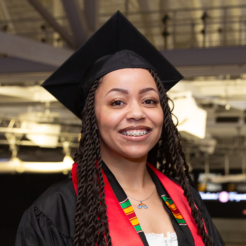 Samantha Carter in black graduation cap and gown smiles after addressing the graduating class of 2024.