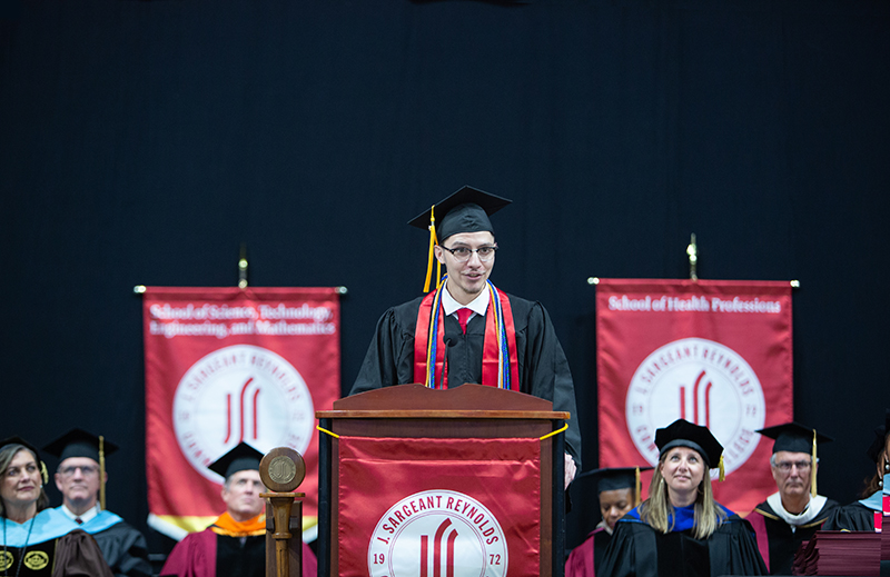 Sebastian Portillo, student graduation speaker, Spring 2025, at podium