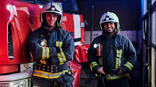 Firefighters battling a raging forest fire, their determined faces masked, as they stand united against the destructive force of nature.