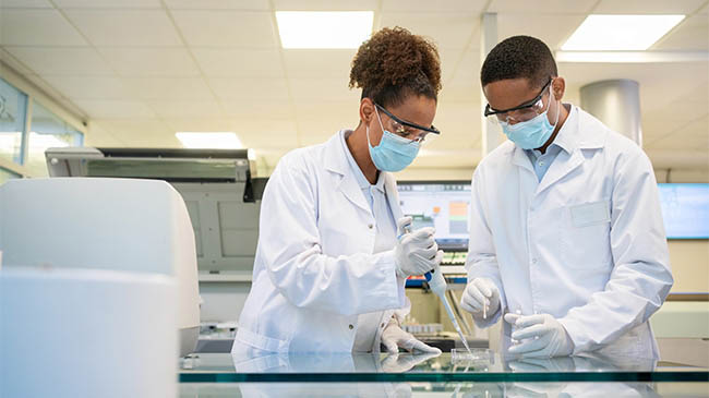 two students practicing in a lab setting